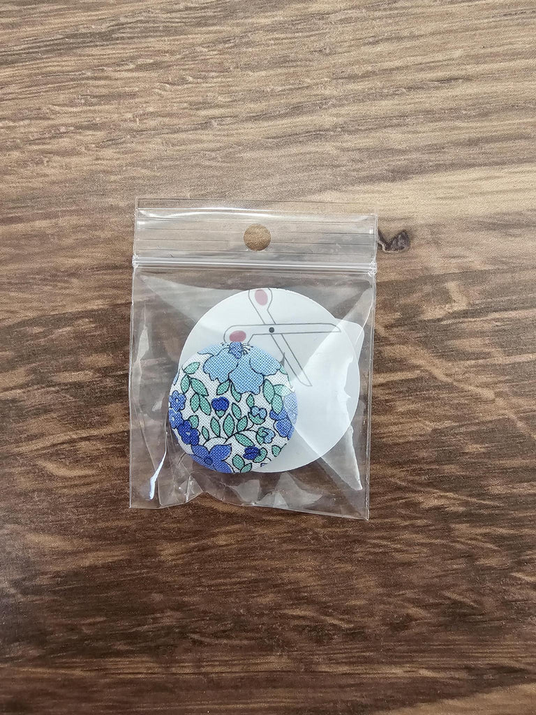 Blue flowers on fabric button magnet